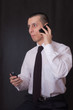 young businessman talking on two phones young businessman talking on two phones