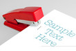 red stapler lies on a white background
