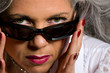 Woman looking over sunglasses