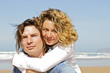 Photo: Young couple in love having fun at the beach Young couple in love having fun at the beach