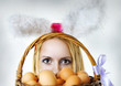 easter bunny woman looking over eggs basket