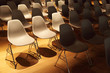 several rows of white plastic chairs with metal legs