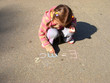 girl drawing on asphalt family house and physics formula