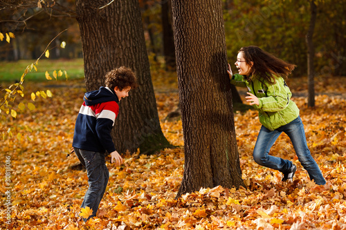 Photo: Kids playing in autumn park Kids playing in autumn park