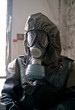 Member of nuclear protection crew in old protective suits and ga