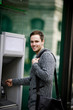 A young man using a cash machine