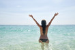 Happy young woman in sea with open hands and jump,Maya Bay, Koh Happy young woman in sea with open hands and jump,Maya Bay, Koh