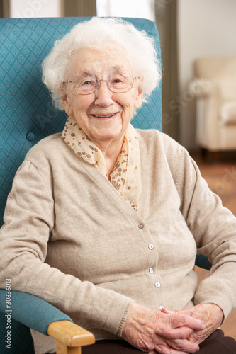 Photo: Senior Woman Relaxing In Chair At Home Senior Woman Relaxing In Chair At Home