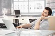 Young stock broker on phone sitting at desk Young stock broker on phone sitting at desk