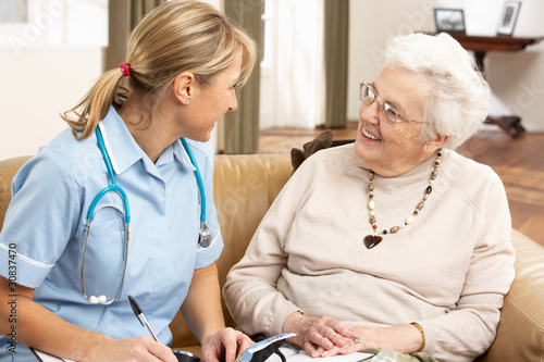 Photo: Senior Woman In Discussion With Health Visitor At Home Senior Woman In Discussion With Health Visitor At Home