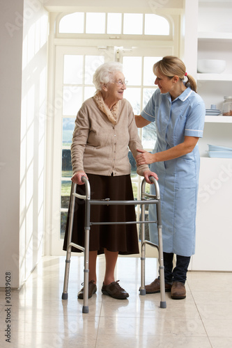Photo: Carer Helping Elderly Senior Woman Using Walking Frame Carer Helping Elderly Senior Woman Using Walking Frame