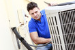 Technician inspects an AC unit