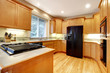 Kitchen with open floor plan and black appliances