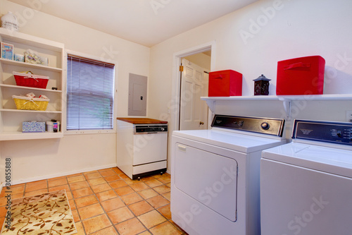 Photo: Laundry room with window and ceramic tile floor. Laundry room with window and ceramic tile floor.