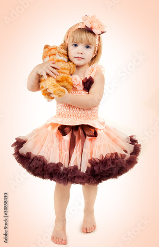 Photo: Portrait of the beautiful girl in a pink dress Portrait of the beautiful girl in a pink dress