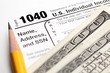 Tax time - Closeup of U.S. 1040 tax return with pencil and money