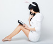 serious young woman sitting with tablet pc