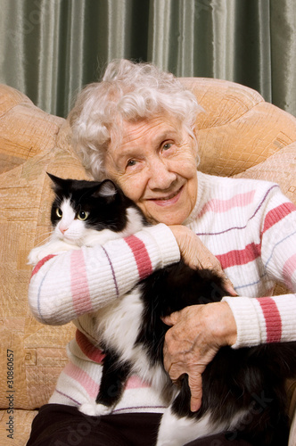 Photo: The grandmother with a cat on a sofa The grandmother with a cat on a sofa