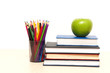 apple, books and colored pencil