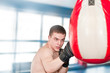 Boxer with punch bag in action Boxer with punch bag in action