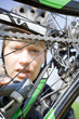 Woman repairing bicycle outdoors Woman repairing bicycle outdoors