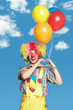 Photo: Portrait clown with balloons against the blue sky Portrait clown with balloons against the blue sky