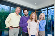 Happy parents standing with adult children