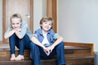 Foto: Brother and sister sitting on wooden steps Brother and sister sitting on wooden steps
