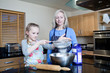 Grandmother and granddaughter baking in kitchen