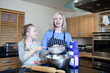 Grandmother and granddaughter baking in kitchen