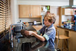 Boy doing the dishes in kitchen