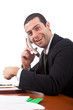 Smiling businessman talking at the phone