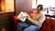 man in cafe with newspaper
