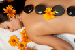 Woman getting a hot stone massage at spa salon