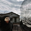 masked evil figure behind threaded window