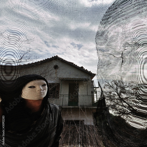 Photo: masked evil figure behind threaded window masked evil figure behind threaded window