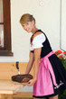 Junge Frau im Dirndl mit Speckplatte