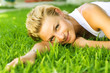 Beautiful healthy Young Woman relaxing on the green grass