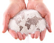 Sand with map of the world in the hands