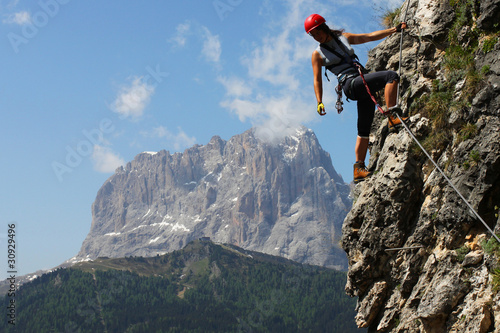 Photo: Young woman climbing in the Dolomits, Italy Young woman climbing in the Dolomits, Italy