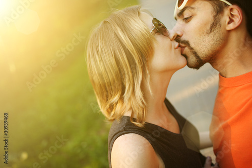 Photo: Couple in love kissing outdoors. Copyspace. Couple in love kissing outdoors. Copyspace.