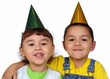 Photo: boy and girl with party hats together boy and girl with party hats together