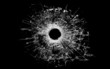 bullet hole in glass isolated on black bullet hole in glass isolated on black