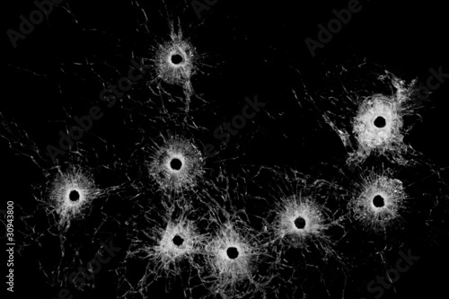 Photo: Broken glass - bullet holes isolated on black Broken glass - bullet holes isolated on black