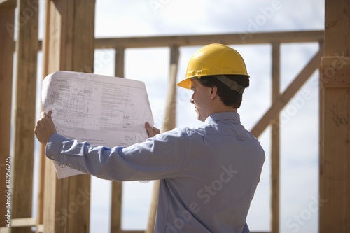 Photo: Site manager with building plans Site manager with building plans