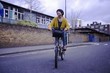 A young female adult riding her bicycle