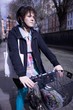 A female adult riding her bicycle