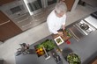 Mid- adult chef prepares salad, overview