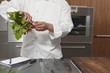 Mid- adult chef preparing radishes