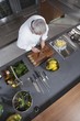 Mid- adult chef working, overview